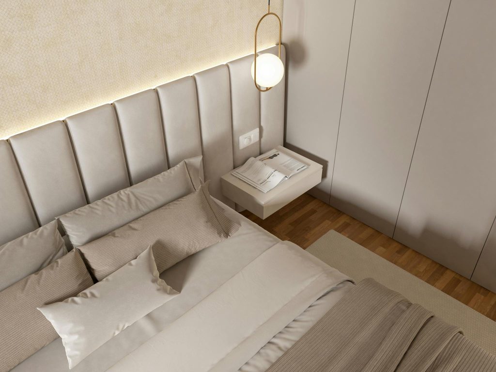 A stylish and modern bedroom interior featuring luxury bedding and contemporary design elements.